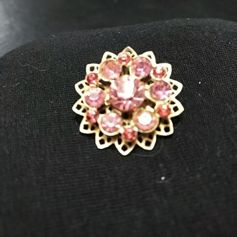 Gold tone flower pin with pink stones brooch